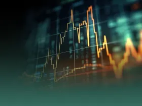  Zbliżenie na ekran z wykresami giełdowymi, symbolizujące rynek finansowy i kryptowaluty